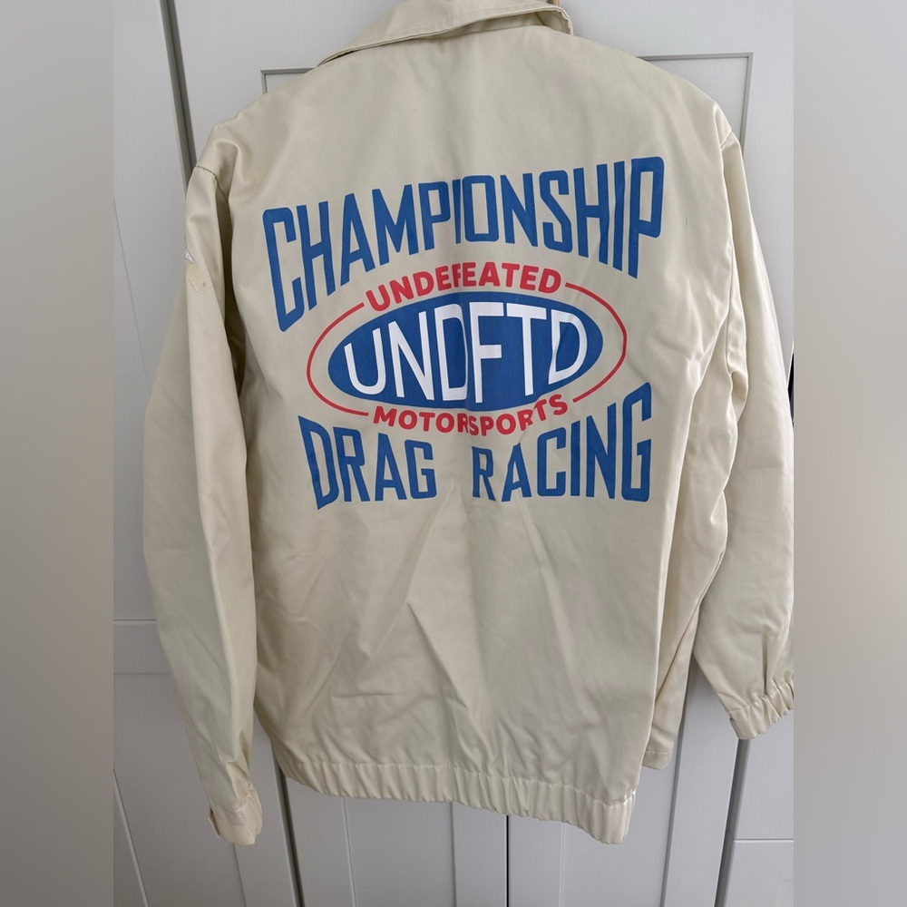 Undefeated brand racing jacket. Brand new with tags. Size large.